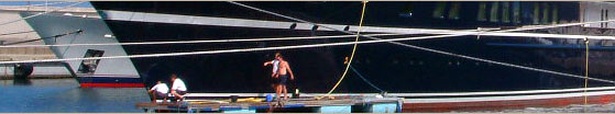 Detail from photograph of large yacht in harbour with 3 people